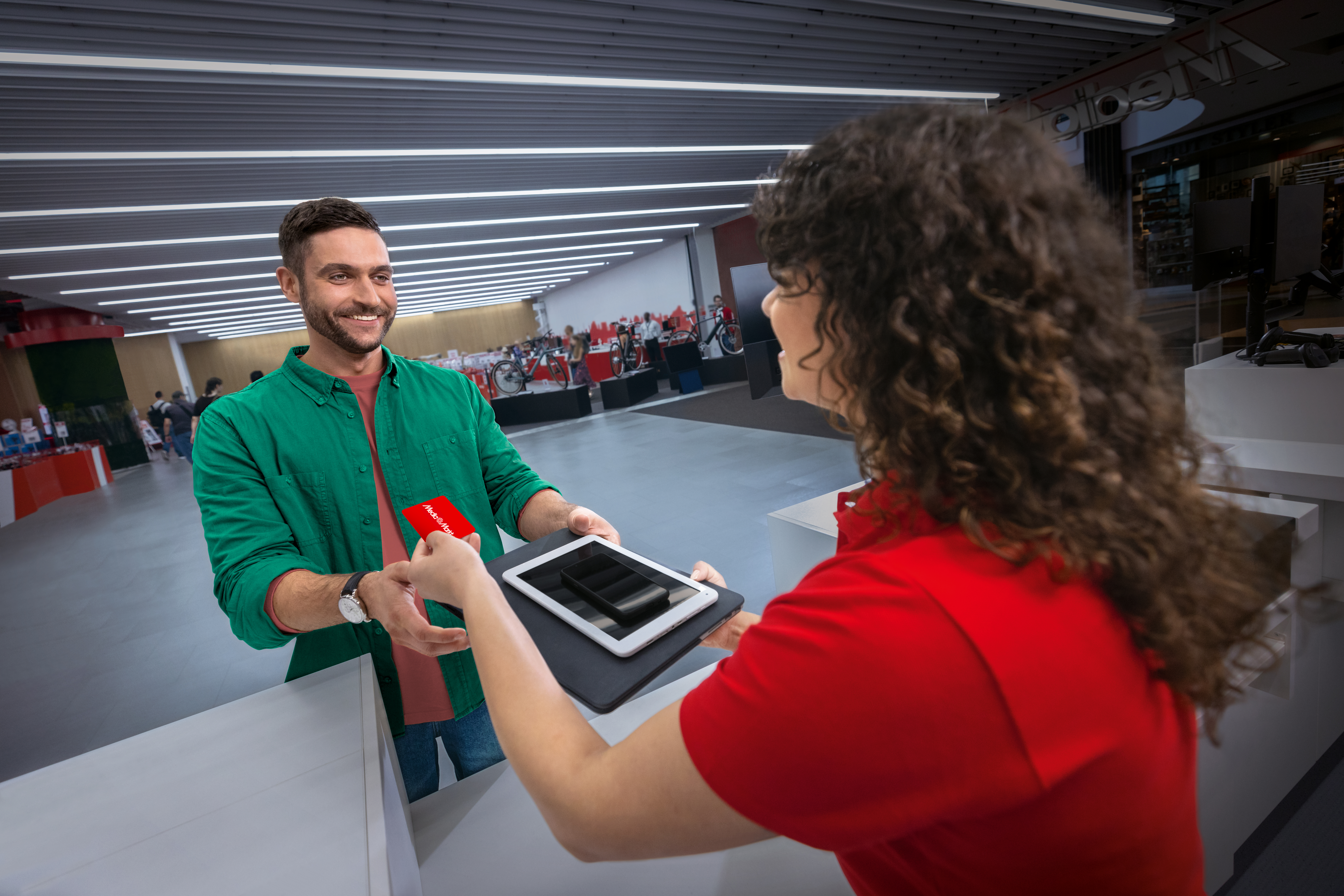 Ein Mann verkauft seine gebrauchten Geräte und erhält dafür eine MediaMarkt-Geschenkkarte.